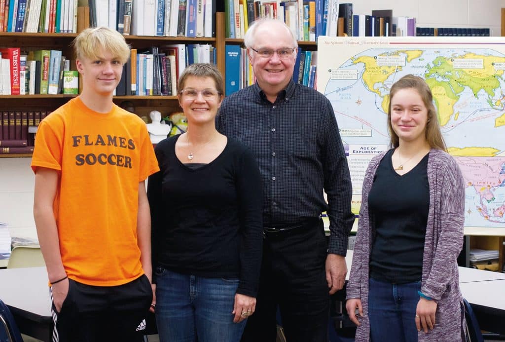 Leo Heatwole ’68, daughter Carmen Miller ’92, and grandchildren Clint Miller (left) ’22 and Ginny Miller (right) ’20 have studied in the same high school classroom.
Photo by Andrew Gascho.
