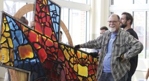Jerry Holsopple with his stained glass cross